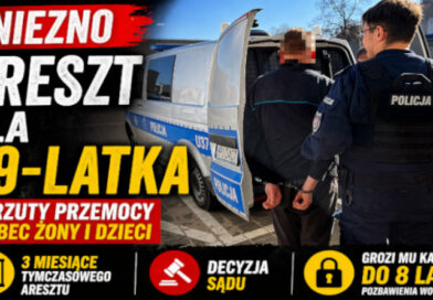 Gniezno – policjant prowadzi zatrzymanego mężczyznę do radiowozu po interwencji